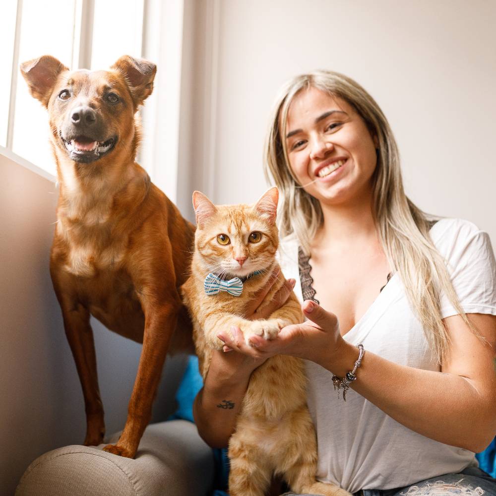 Woman with dog and tabby cat